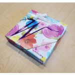 Floral-patterned gift box with a white ribbon bow
