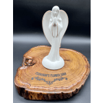 White angel figurine on a wooden display base