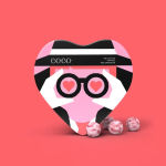 Heart-shaped chocolate box with pink and black graphic design and truffles