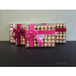 Three boxes of Ferrero Rocher chocolates tied with pink and burgundy ribbons