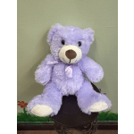 Lavender teddy bear with a satin ribbon sitting on a stool