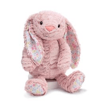 Pink plush bunny with patterned ears and feet sitting on a white base