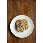 Three chocolate chip cookies on a white plate