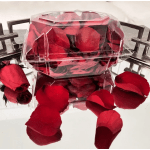 Clear boxes filled with red rose petals and loose petals around them