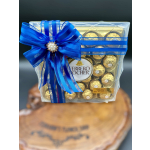 Ferrero Rocher chocolates in a clear gift box with a blue ribbon bow