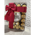 Box of Ferrero Rocher chocolates tied with a red ribbon and bow