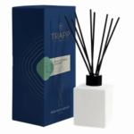 Reed diffuser with a white bottle and black reeds beside a blue box