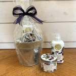 Gift set with cherry-scented lotion, candle, and a wrapped basket