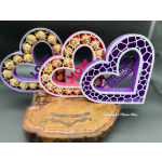 Heart-shaped candy display with birthday lettering on a wood base