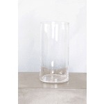 Tall clear glass cylinder vase on a neutral surface