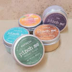 Five small tins of Pinch Me therapy dough in assorted colors