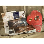 Assorted boxes of chocolates and truffles arranged in a display.