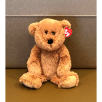 Plush teddy bear sitting upright with a red heart tag
