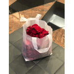 Red rose petals in a translucent gift bag