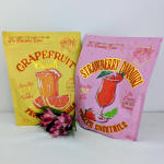 Two frozen cocktail mix pouches with a small pink flower bunch in front