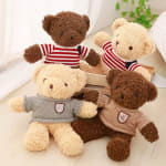 Four teddy bears in knit sweaters arranged in a box