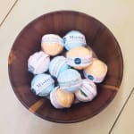 Assorted bath bombs in a wooden bowl