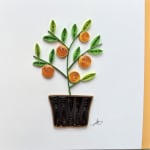 Paper quilling of a potted flowering plant with orange blossoms