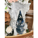 Faceted dark blue crystal ornament in front of white roses