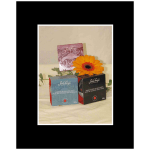 Three seafood gift boxes with an orange gerbera daisy
