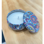 Decorative patterned candle tin with a white candle and matching lid