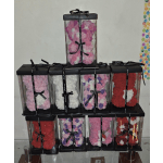 Stacked clear gift boxes filled with rose-shaped flowers in pink, white, red, and purple.