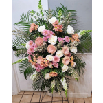 Large standing floral spray with pink and white blooms and palm fronds