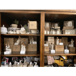 Shelves of giftware with mugs, figurines, and small decorative items