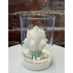 White floral candle in a clear glass container