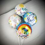 Four get-well balloons with colorful designs and messages