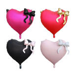 Four heart-shaped balloons with bow accents in pink, red, black, and blush