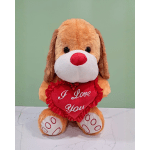 Plush dog holding a red heart that says "I Love You"