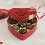 Heart-shaped chocolate box with Valentine’s Day lid and assorted chocolates