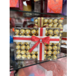 Boxed Ferrero Rocher chocolates tied with a red ribbon