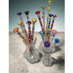 Two glass vases filled with colorful beaded sticks topped with faceted gems
