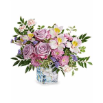 Lavender roses and pink flowers in a glass vase