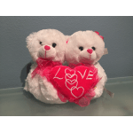 Two white teddy bears holding a red heart with "LOVE" text