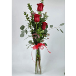 Tall vase arrangement of red roses with greenery and a red ribbon