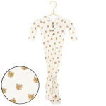 White baby gown with teddy bear print hanging on a gold hanger