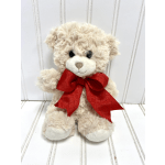 Plush teddy bear with a red ribbon bow