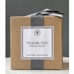 Gift box with a thank-you candle label and gray ribbon