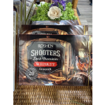 Boxes of whiskey-flavored dark chocolates with a floral display behind them