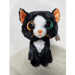 Black-and-white plush cat with large glittery eyes and orange ears