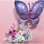 Pastel floral arrangement with a purple butterfly balloon and a small teddy bear card.