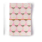 Pink floral-patterned notebook with a yellow elastic band