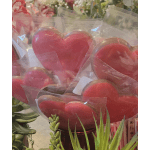 Heart-shaped red cookies wrapped in clear plastic bags