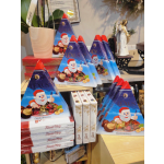Christmas chocolate gift boxes stacked on a shelf with a potted plant