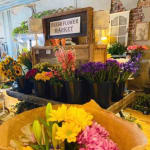 Flower market display with assorted bouquets in buckets