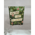 Decorative card with clover and flower pattern reading "HOW DID I GET SO LUCKY?"