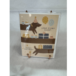 Birthday card with a dog, cakes, balloons, and gift boxes